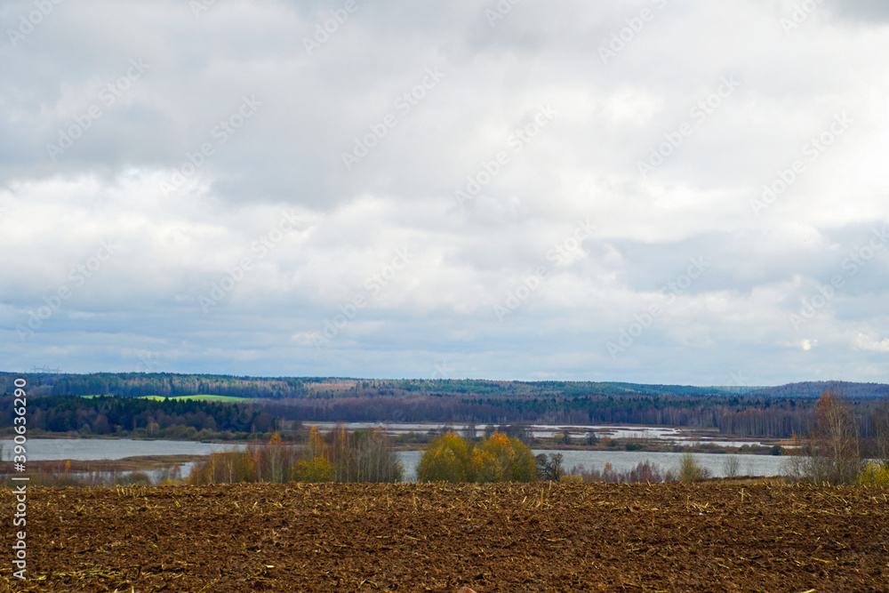 Autumn landscape Early November Beautiful view of meadows and groves Horizon and open spaces Sky and lake