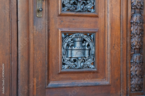 Metal castle symbol on a wooden vintage door brown