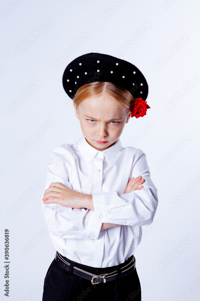 five-year-old girl stands frowning and crosses her arms on her chest five-year-old girl stands frowning and crosses her arms on her chest