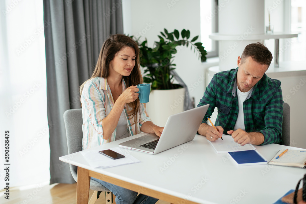 Husband and wife preparing bills to pay. Young couple using laptop.. Husband and wife preparing bills to pay. Young couple using laptop..