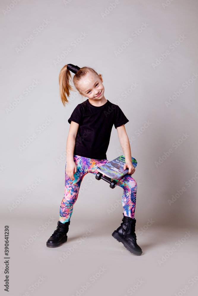 cute five year old girl in black trowel and sports colored leggings ...