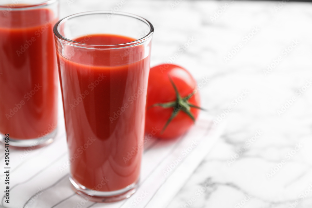 Delicious fresh tomato juice on white marble table, closeup. Space for text Delicious fresh tomato juice on white marble table, closeup. Space for text