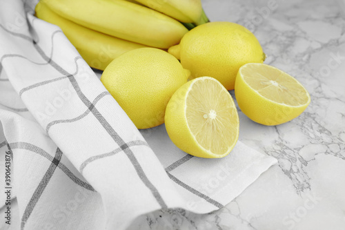 Lemons and banans on marble backgroung. Cut fruits. Organic fruit.      photo