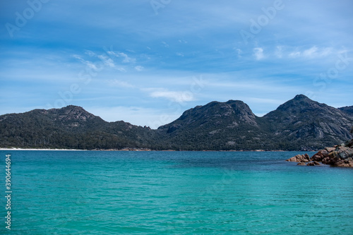 View of the coast of the Freycinet Peninsula, Tasmania from a boat on a sunny day