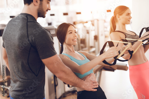 Athletic girl shakes the body in the gym.