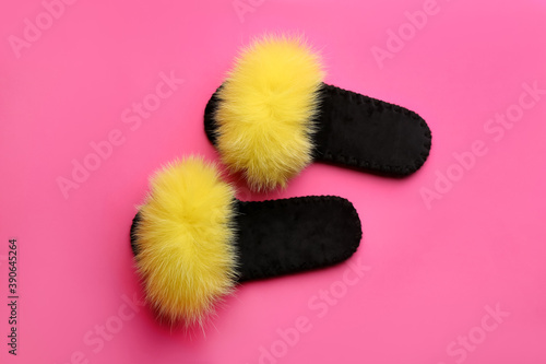 Pair of soft slippers on pink background, flat lay
