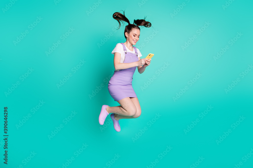 Full length body size side profile photo of female blogger texting on smartphone using app isolated on bright teal color background Full length body size side profile photo of female blogger texting on smartphone using app isolated on bright teal color background