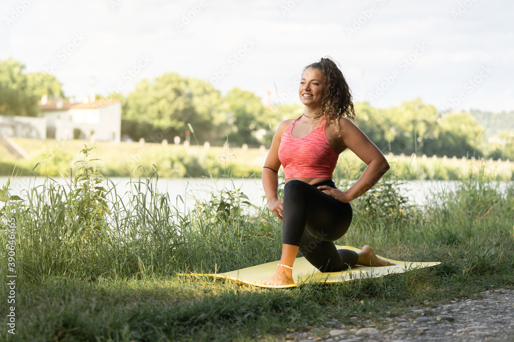 girl or woman doing sports outdoors near a river, nature