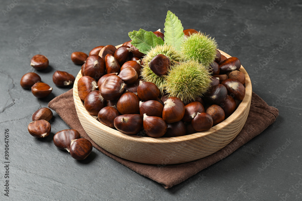 Fresh sweet edible chestnuts on black slate table Fresh sweet edible chestnuts on black slate table