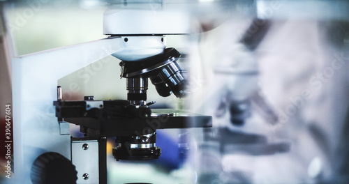 Close up on microscope and laboratory glassware. Modern laboratory interior