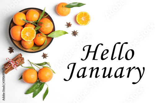 Greeting card with text Hello January. Ripe tangerines, cinnamon sticks and anise stars on white background, flat lay