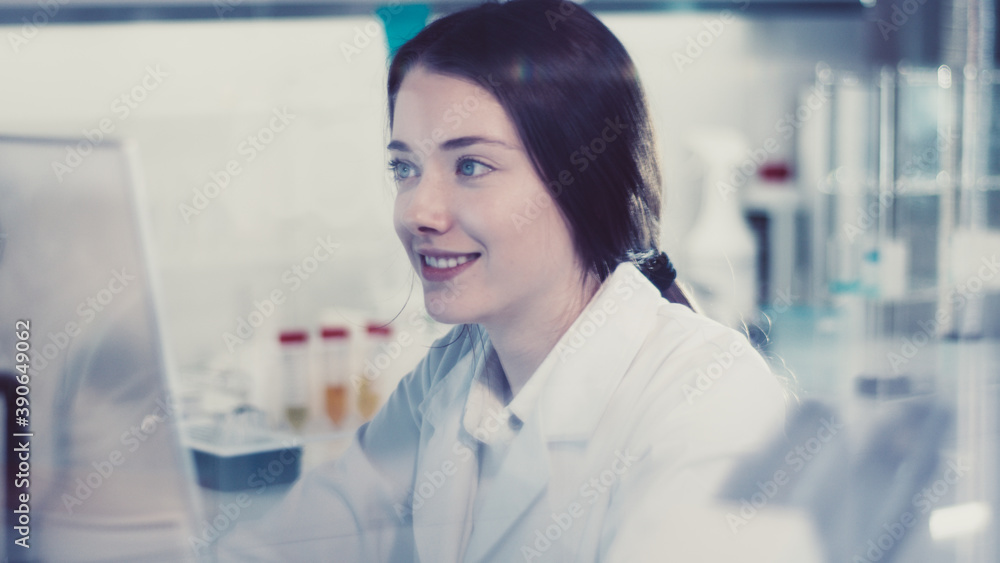 Modern laboratory. Female scientist working with microscope. Testing blood samples