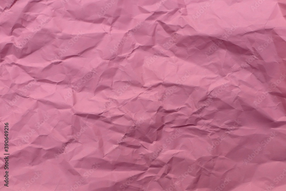 Fototapeta premium Pink crumpled paper textured background.