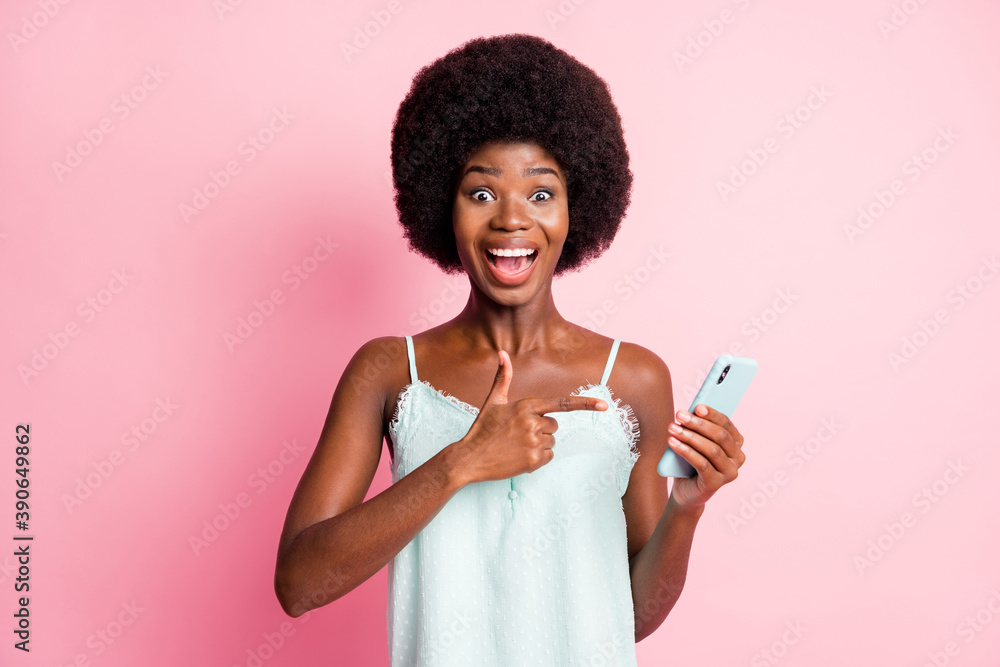 Portrait of pretty brown haired stylish trendy woman wear singlet point hold promotion smartphone isolated on pink color background Portrait of pretty brown haired stylish trendy woman wear singlet point hold promotion smartphone isolated on pink color background