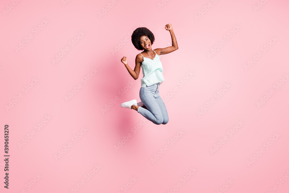 Full size portrait of attractive curly hairstyle person jump high fists up open mouth isolated on pink color background