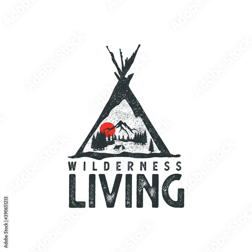 Hand drawn wilderness badge with mountain landscape and inspiring lettering 