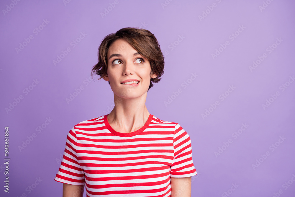 Photo of pretty young lady interested look up empty space bite lip wear striped t-shirt isolated violet color background Photo of pretty young lady interested look up empty space bite lip wear striped t-shirt isolated violet color background