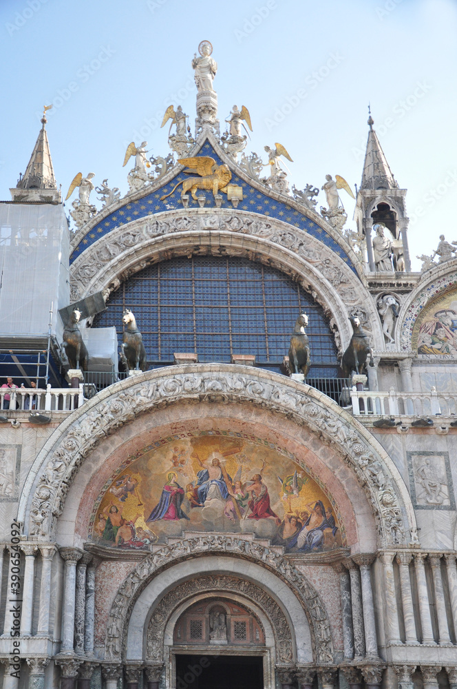 The beautiful Basilica of St Mark in Venice. This is a beautiful and ornate buildings in Venice. The image includes the distinguished winged Lion of Venice.
