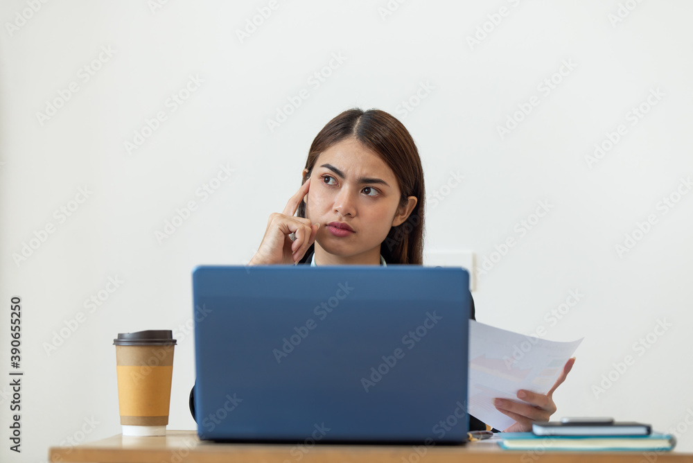 Happy young Asian business woman thinking dreaming has many ideas while working in office Happy young Asian business woman thinking dreaming has many ideas while working in office