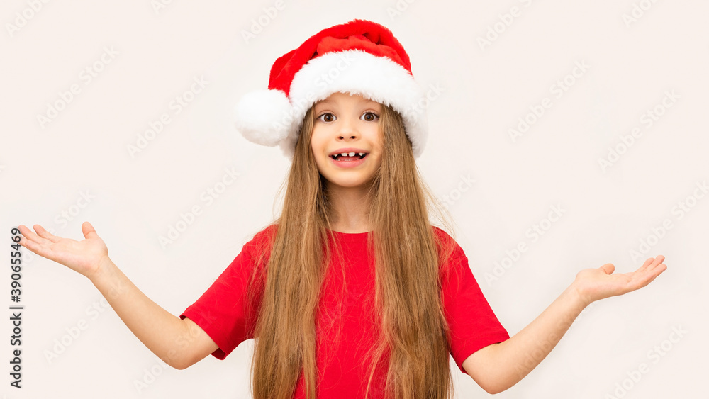 Little girl spreads her hands to the side on a white background on Christmas day. Little girl spreads her hands to the side on a white background on Christmas day.