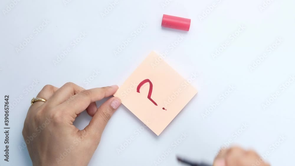 high angle view of question mark on paper on white background high angle view of question mark on paper on white background