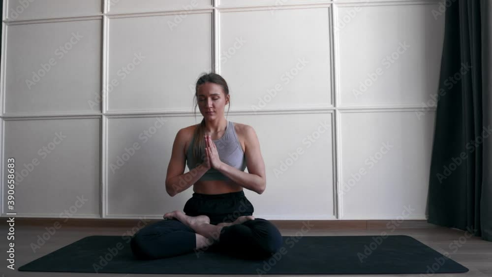 beautiful woman praying at home in yoga asana and meditating beautiful woman praying at home in yoga asana and meditating