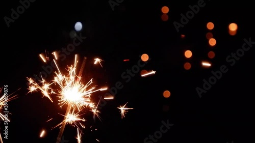 slow video clip of a yellow scab splashing from fireworks and Black background with blurry light.