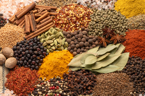 Assortment of aromatic spices and herbs background