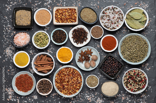 Assortment of aromatic spices and herbs in small bowls © photka