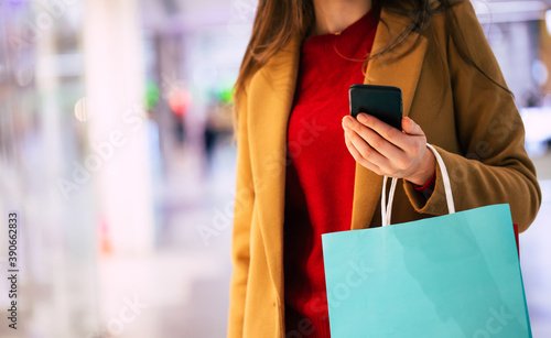Close up photo of woman with shopping bag in the mall while buying some clothes