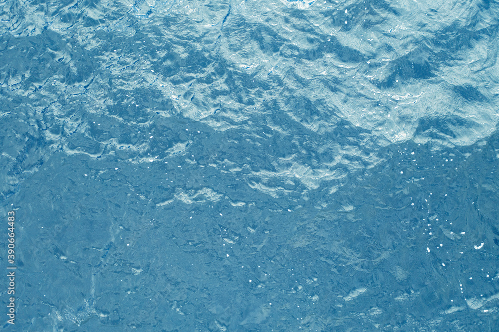 Aerial view of a crystal clear sea water texture. Top view from above Natural blue background. Blue water reflection. Blue ocean wave. Summer sea. Drone. Top view