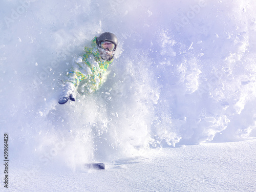 Snowboarder on snowboard rides through snow, explosion. Freeride in winter Ski Resort