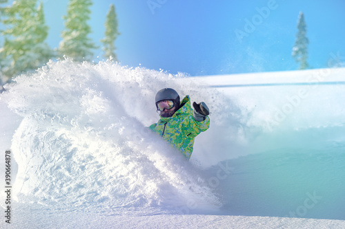 Snowboarder on snowboard rides through snow, explosion. Freeride in winter Ski Resort