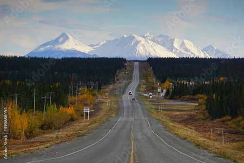 Road in Yukon with high white mountains in front