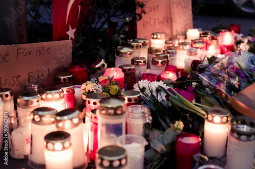 Hanau, Germany - February 20 2020: Flowers and Candles at the Hanau shooting site as a remembrance to the victims. Right extremism. Terror attack.