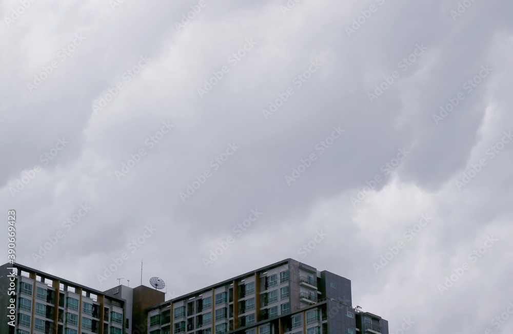 Fototapeta premium Grey stormy clouds over the high buildings before the rain