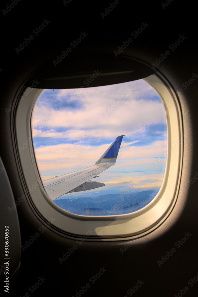 Looking out of a airplane window at the wing. Looking out of a airplane window at the wing.