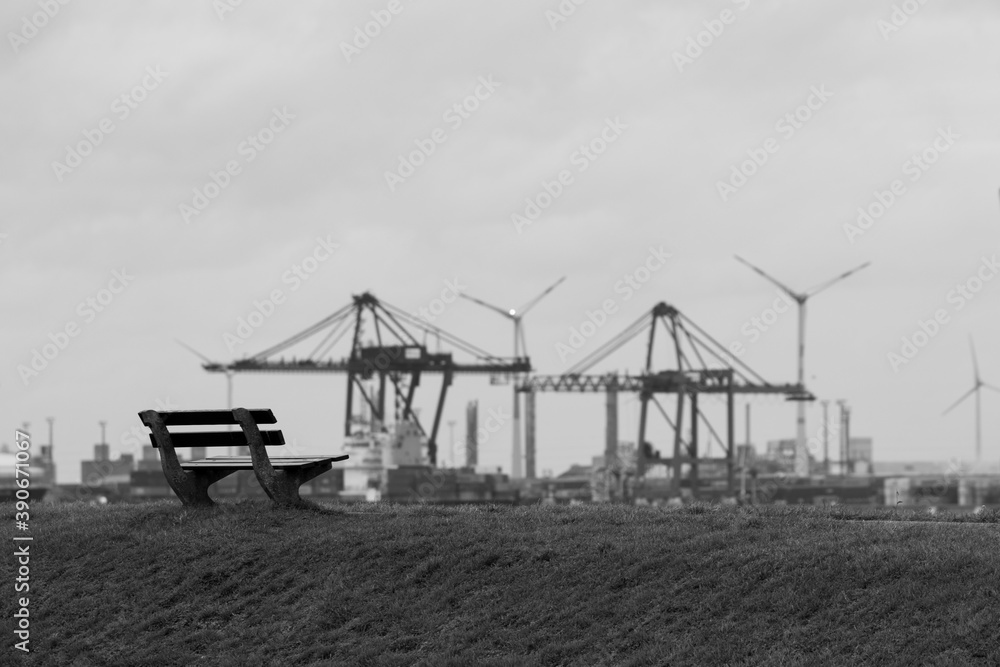 park bench facing industrial view black and white park bench facing industrial view black and white