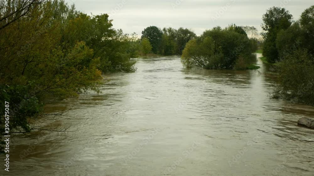 Flood river flooding Morava water, flowing floats tree carries trunk downstream, barrage gush jet climate change, environmental disaster landscape, raging sticks logs float down bank foreground stand Flood river flooding Morava water, flowing floats tree carries trunk downstream, barrage gush jet climate change, environmental disaster landscape, raging sticks logs float down bank foreground stand