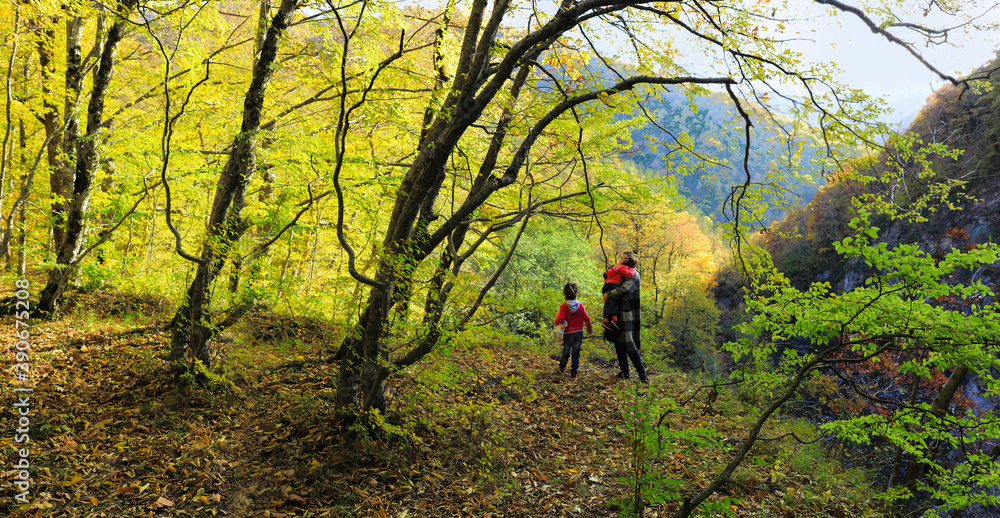 Autumn in the mountains. Family walk in the autumn forest Autumn in the mountains. Family walk in the autumn forest