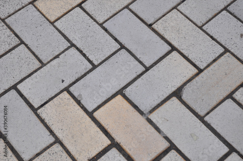 A close up of a paving herringbone pattern background as a common paver pattern for driveways.