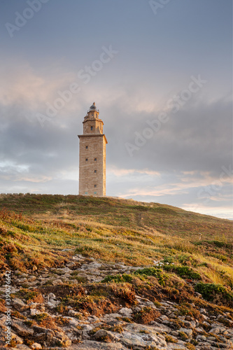 View of Tower of Hercules ancient roman lighthouse at sunset. Copy space