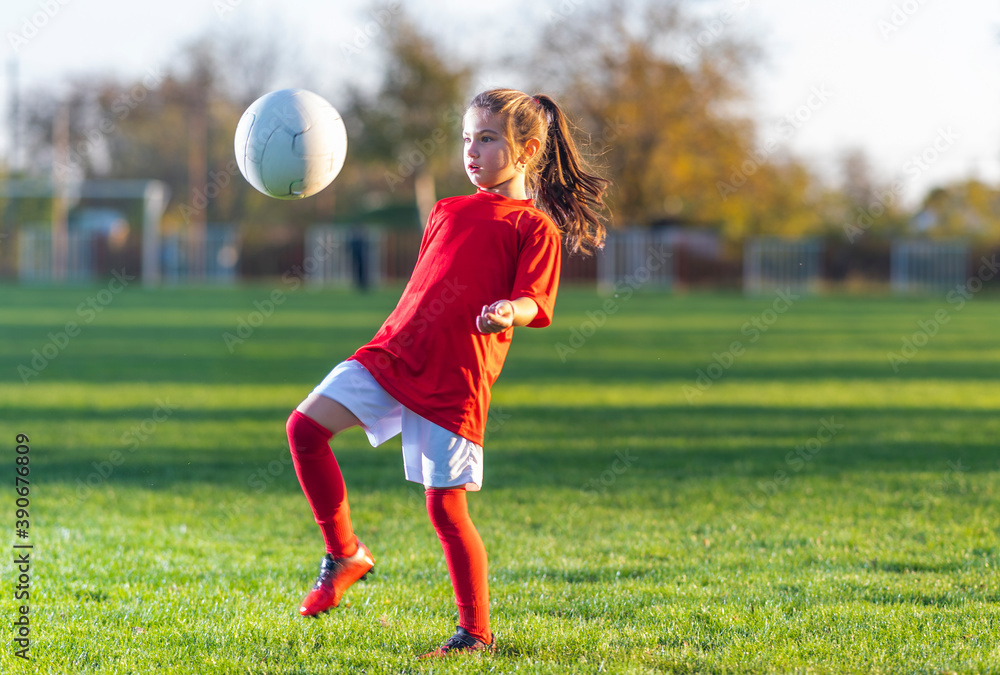 Little girl kicks soccer ball Stock Photo Adobe Stock