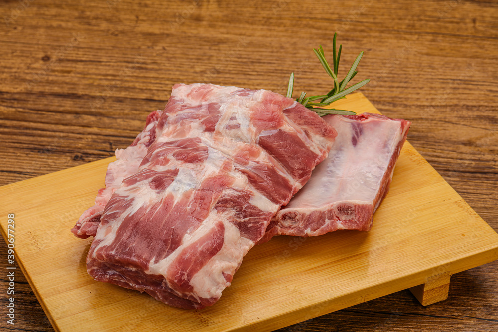 Raw pork ribs served rosemary