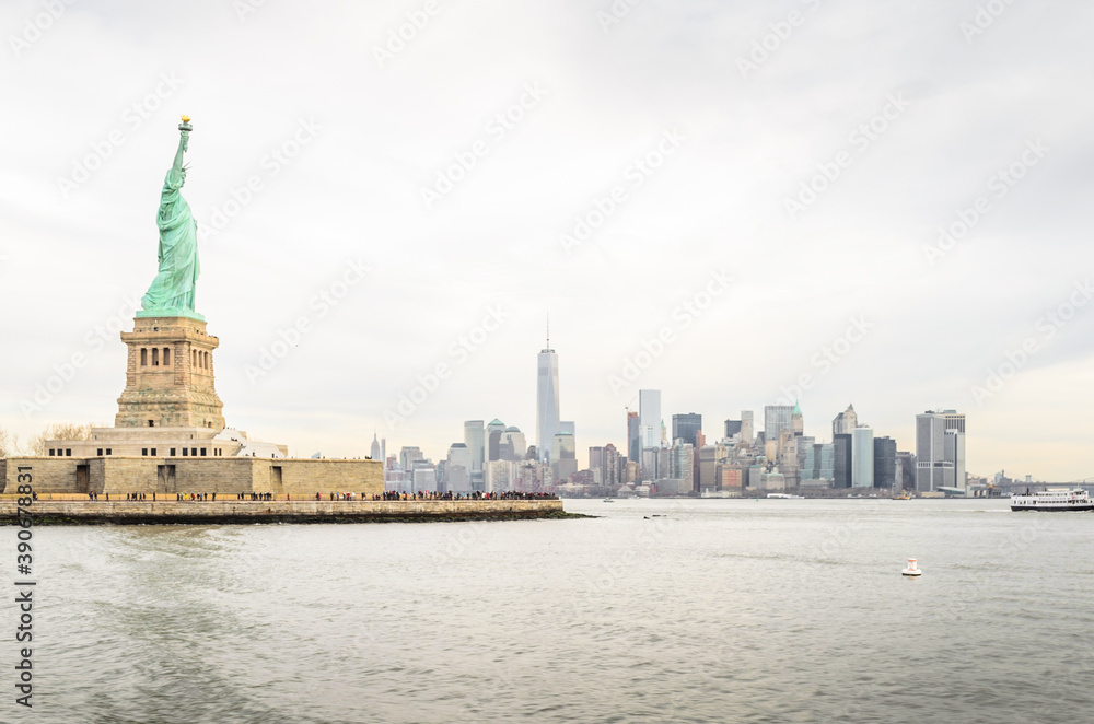 Lady Liberty Statue with Lower Manhattan Futuristic Buildings and Towers in Background. New York City, USA