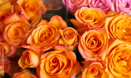 Beautiful bouquets of red  pink and yellow roses in a flower shop. A bright mix of flowers. Handsome fresh bouquets. Flowers delivery. Floral shop concept . Selective focus.