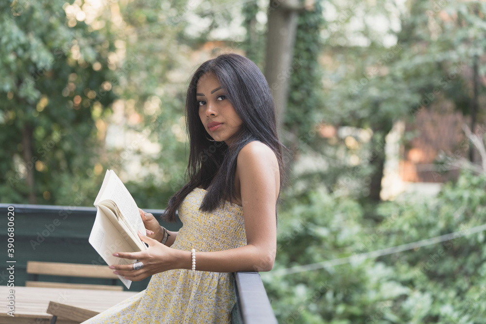 relaxed girl with a book in her hand thinking relaxed girl with a book in her hand thinking