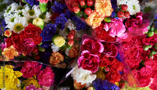 Beautiful bouquets of mixed flowers in a flower shop. A bright mix of flowers. Background on full screen. Handsome fresh bouquets. Flowers delivery. Floral shop concept .