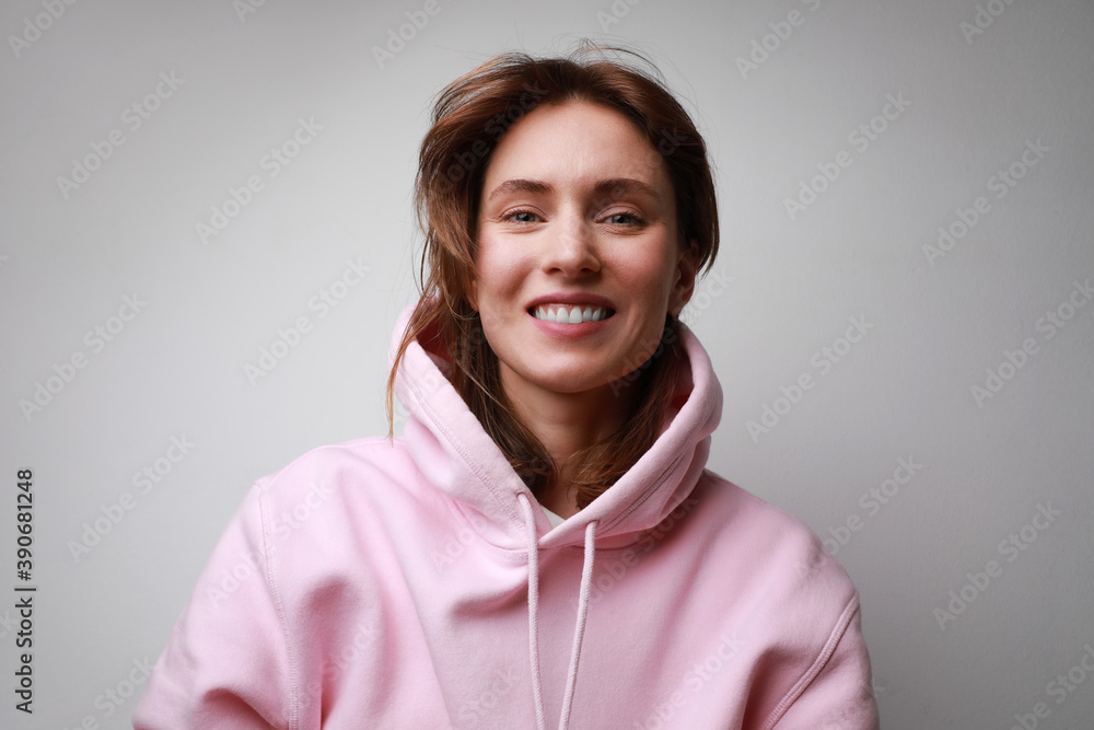 Close-up portrait of happy young woman, smiling isolated on white wall. Close-up portrait of happy young woman, smiling isolated on white wall.