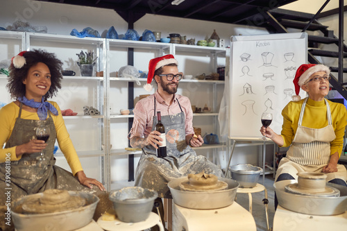 Group of friends having festive themed pottery class  Casual Christmas or New Year celebration